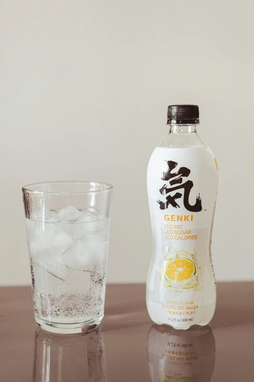 a bottle and a glass on a table, inspired by Kanō Shōsenin, lemonade, 6 pack, hydration, slim