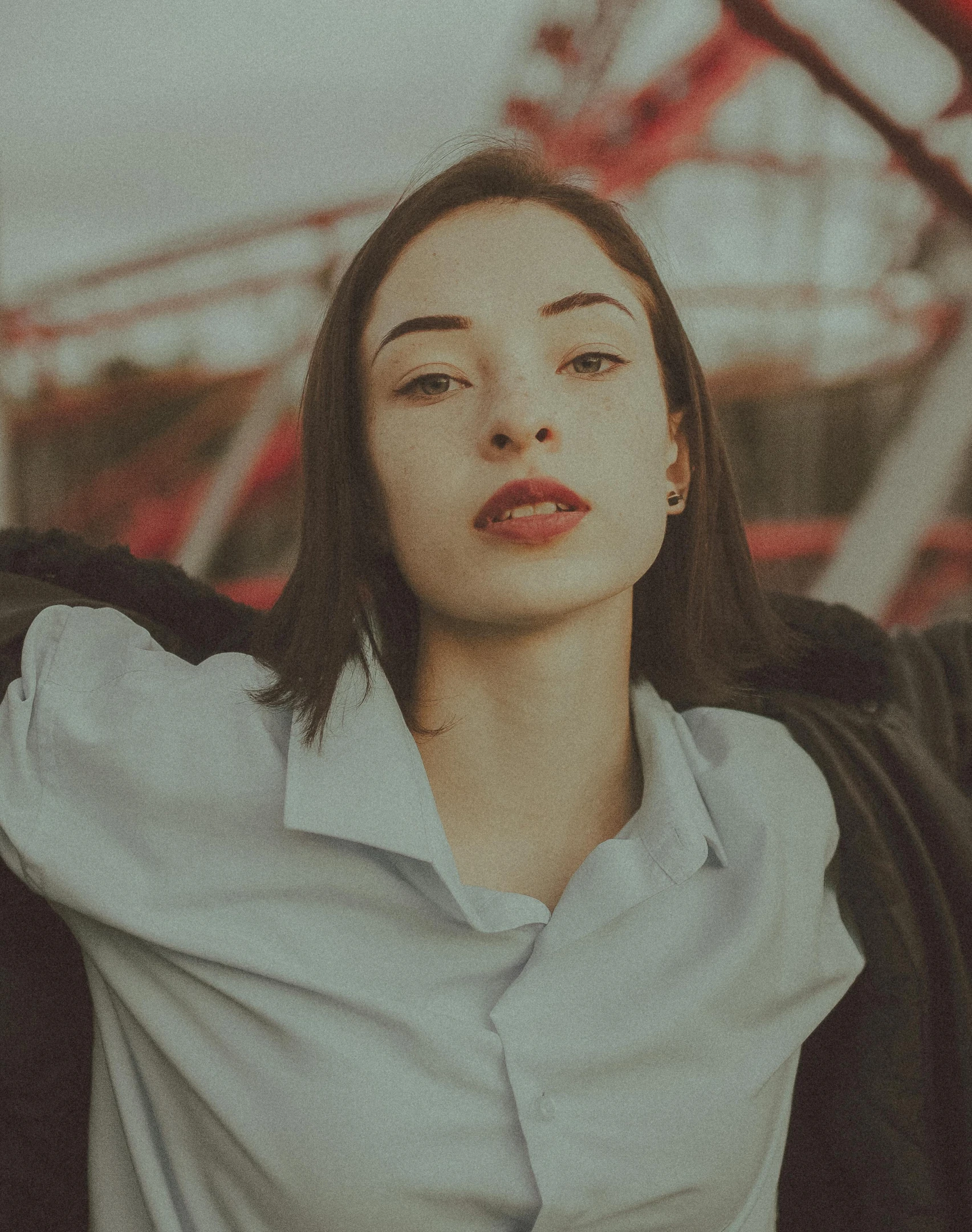 a woman standing in front of a ferris wheel, a polaroid photo, inspired by Elsa Bleda, trending on pexels, antipodeans, both have red lips, portrait sophie mudd, pictured from the shoulders up, 15081959 21121991 01012000 4k