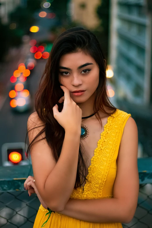 a woman in a yellow dress posing for a picture, by Robbie Trevino, city lights, south east asian with round face, 5 0 0 px models, teenage girl