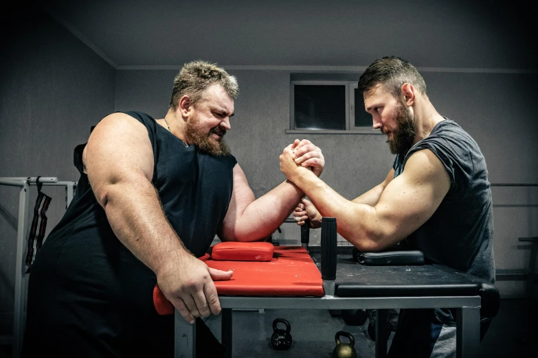 two men arm wrestling in a gym, by Alexander Fedosav, pexels contest winner, three hairy fat cave people, square, aussie baristas, фото девушка курит