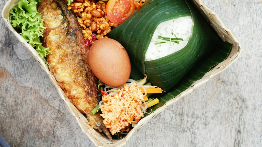 a close up of a box of food on a table, hurufiyya, bangkuart, square, bali, half fish