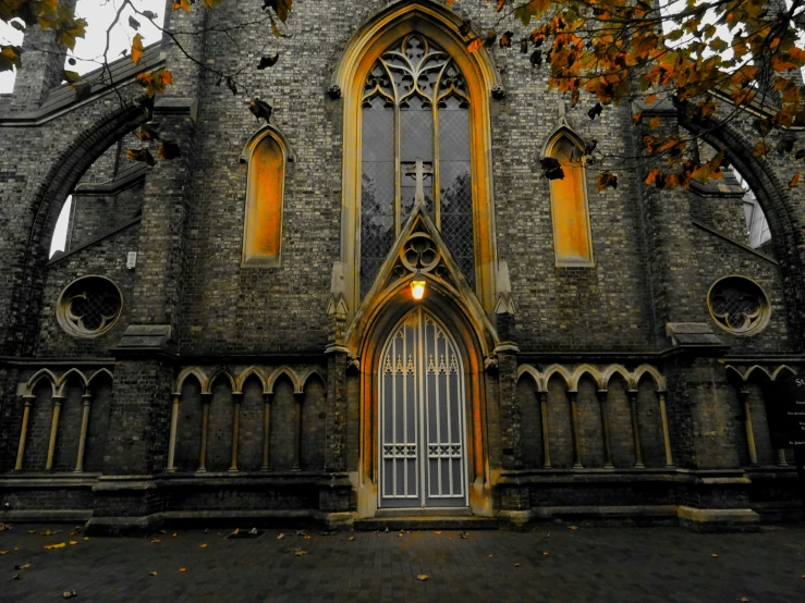 a church with a clock on the front of it, inspired by Sydney Prior Hall, pexels contest winner, gothic art, autumnal, symmetrical doorway, golden windows, grey