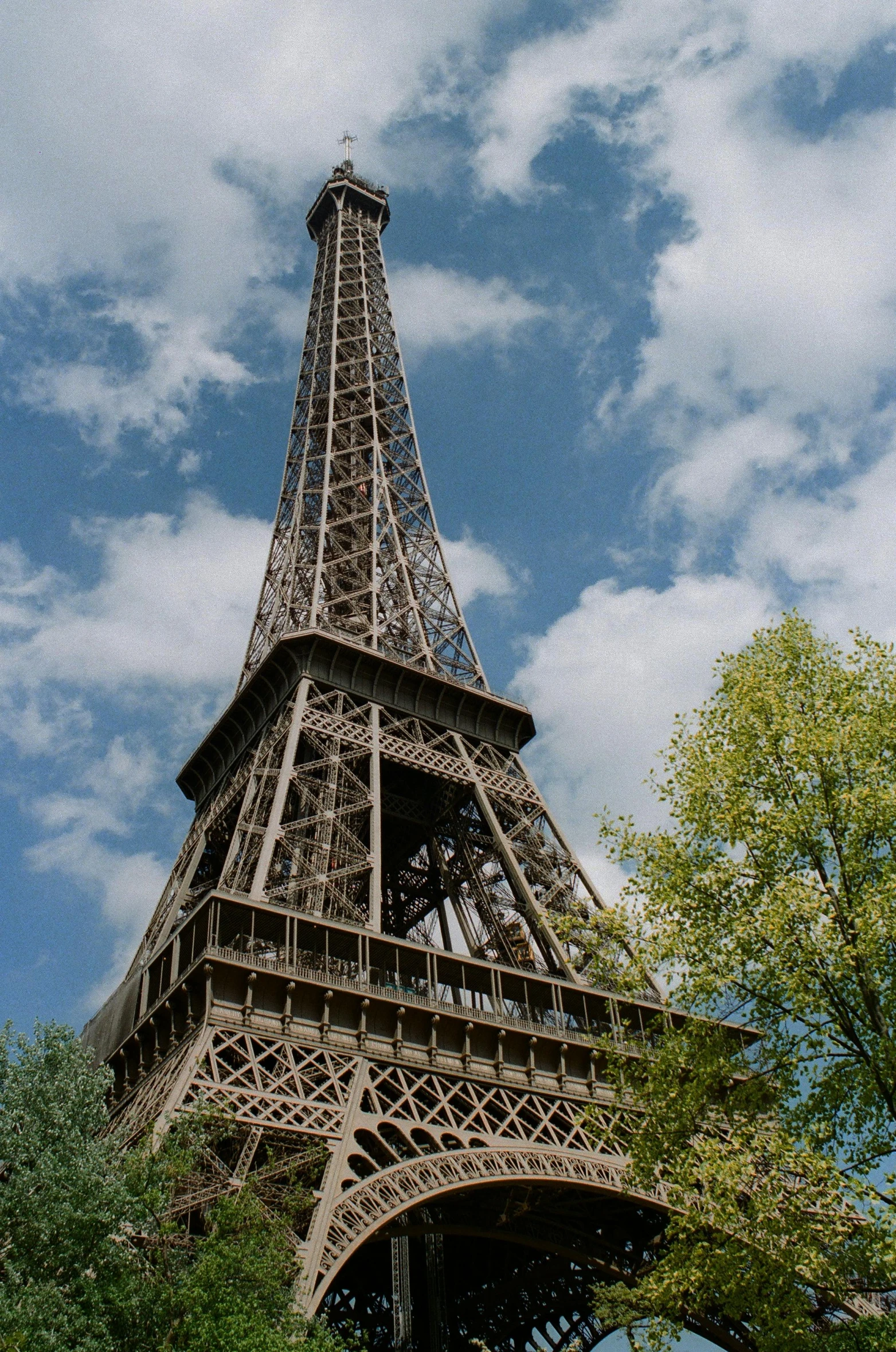 a view of the eiffel tower from below, lush surroundings, chocolate, exterior, no cropping