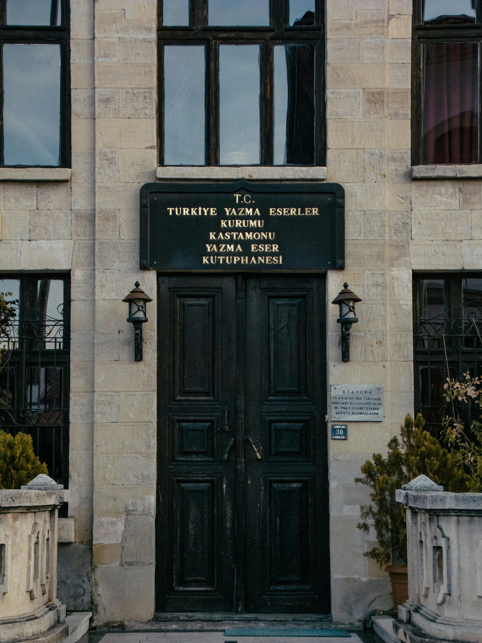 a black door in front of a building, turkish and russian, lawyer, yes, center of picture