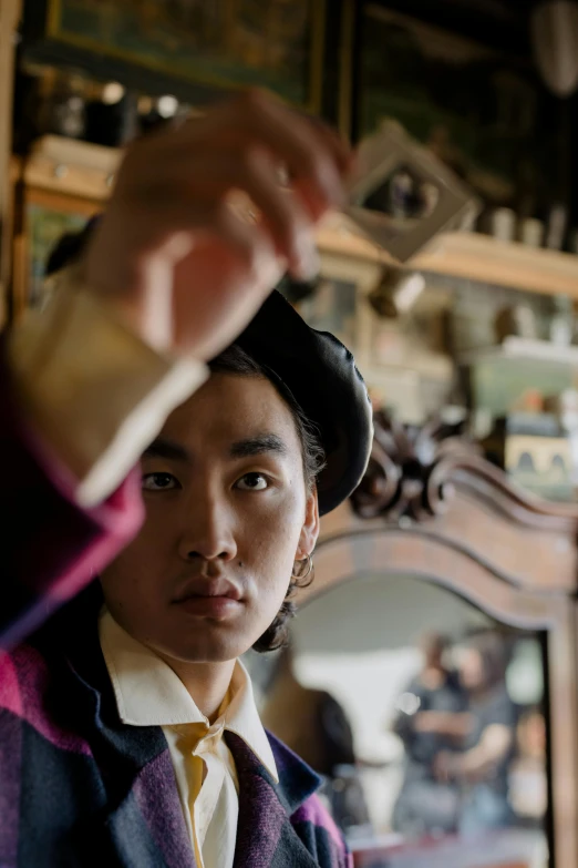 a close up of a person wearing a suit and tie, inspired by Gu An, inside mirror, in historic clothing, a boy, shot with sony alpha