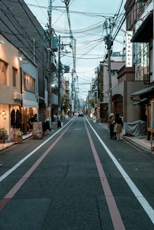 a narrow street lined with shops next to tall buildings, trending on unsplash, ukiyo-e, damaged streets, early evening, photo from 2022, ethnicity : japanese