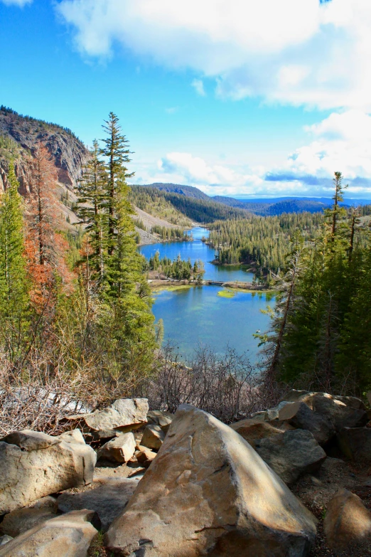 a body of water surrounded by trees and rocks, mammoth, overlooking a valley with trees, red lake, slide show