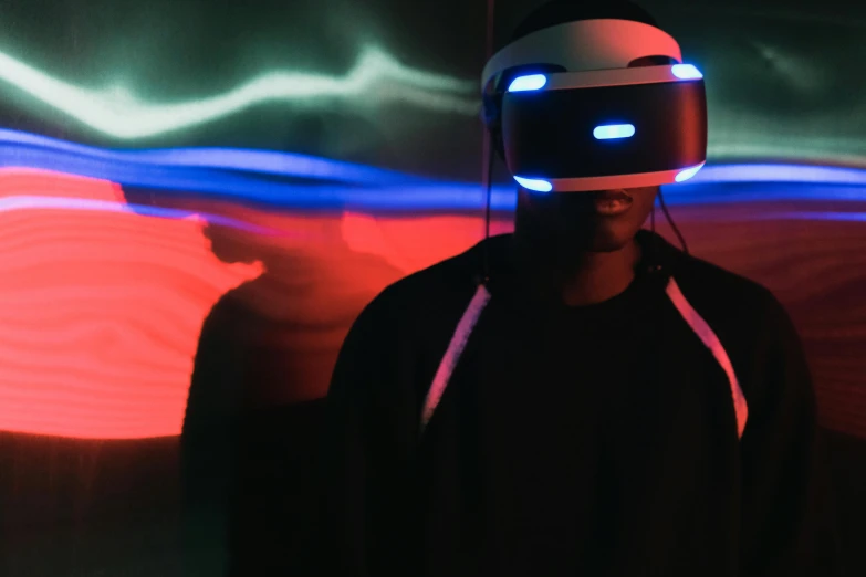 a man wearing a virtual reality headset in a dark room, pexels contest winner, afrofuturism, red and blue lighting, playstation, avatar image