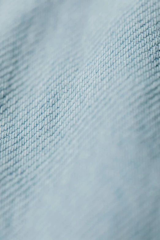 a ladybug sitting on top of a blue blanket, a macro photograph, by David Simpson, 8k fabric texture details, wearing a light blue shirt, detail shot, folds of fabric