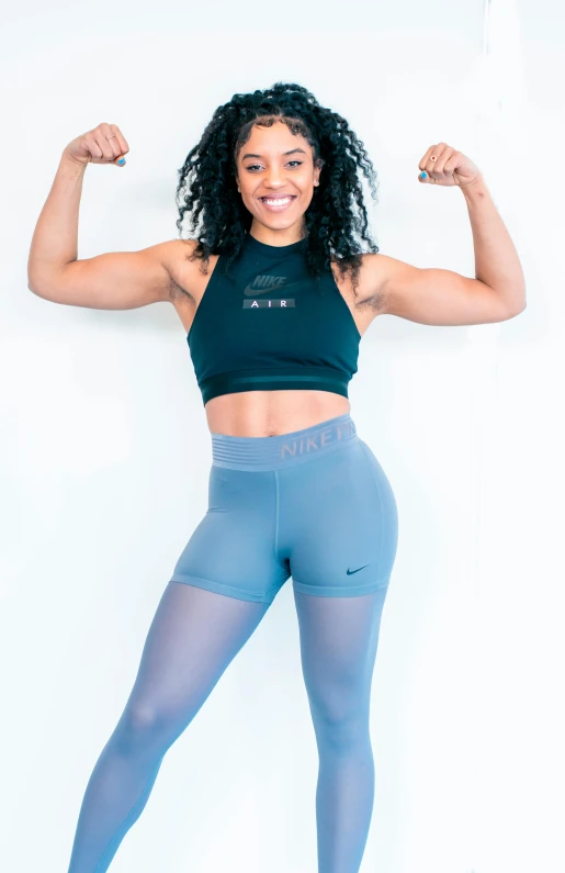 a woman posing with her arms in the air, wearing fitness gear, alexis franklin, on clear background, ariel perez