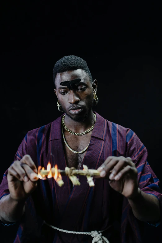 a man holding a piece of food in his hands, an album cover, by Stokely Webster, trending on pexels, hyperrealism, casting a flame spell, playboi carti portrait, billy butcher, holding wands