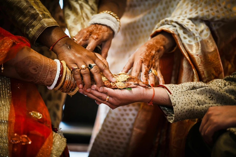 a close up of a person putting a ring on another person's hand, hurufiyya, thumbnail, bollywood, group photo, brown