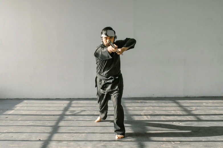 a man standing in a room holding a baseball bat, inspired by Ma Quan, dynamic dancing pose, manuka, black, dao lee