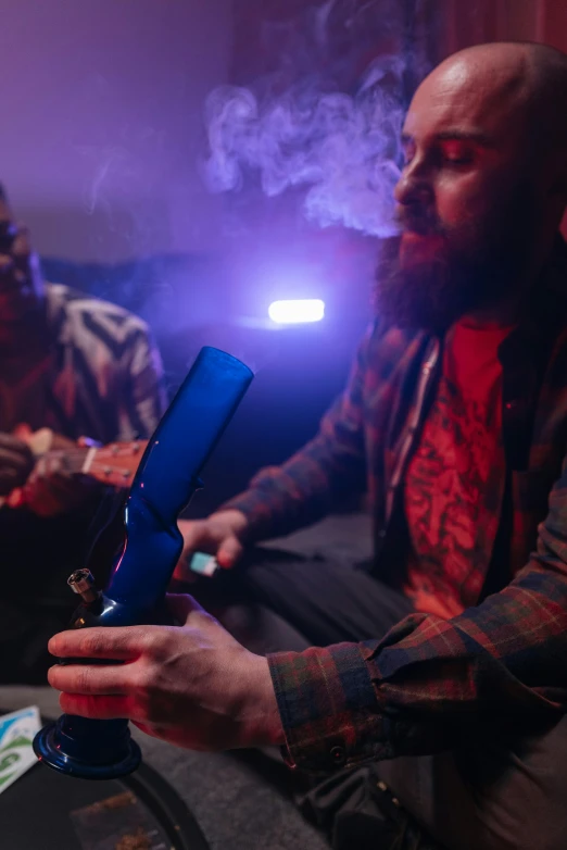a man sitting on a couch with a gun in his hand, smoking a magical bong, cool purple slate blue lighting, two buddies sitting in a room, shot with sony alpha