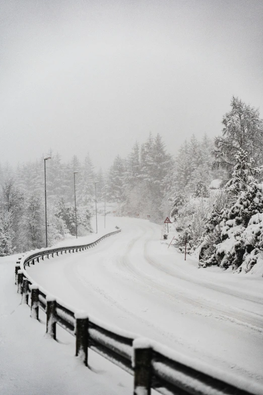 a black and white photo of a snowy road, hurufiyya, taken in the late 2010s, full colour, whistler, promo