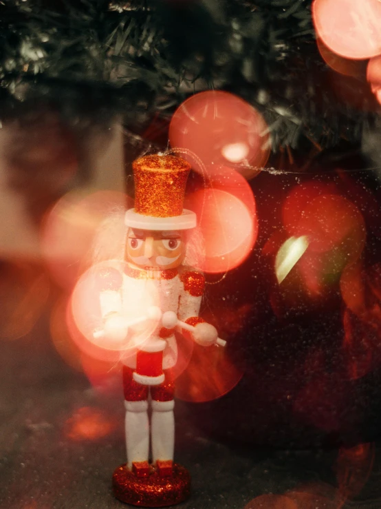 a toy soldier standing in front of a christmas tree, a picture, by Julia Pishtar, pexels contest winner, happening, ballet, gif, glare, red and white color theme