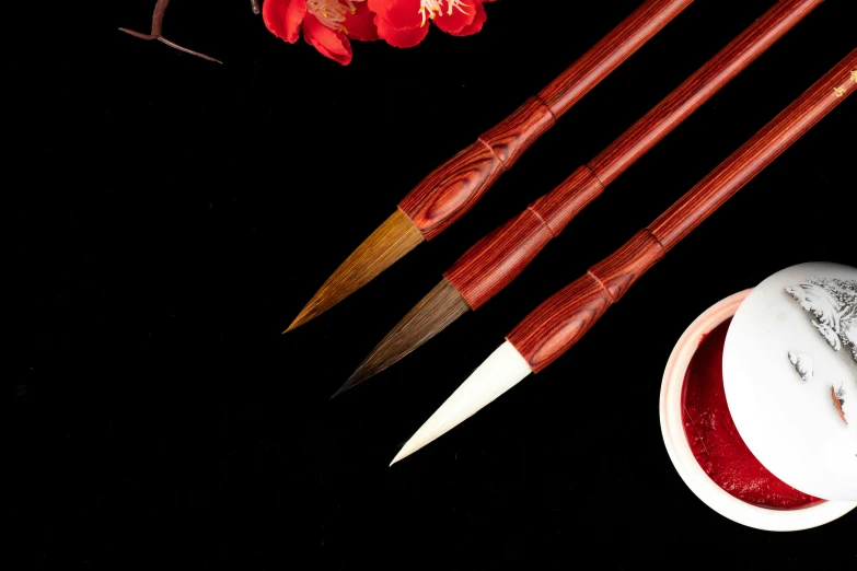 a pair of chopsticks sitting next to a red flower, holding a paintbrush, high quality product image”, brown, dry brush