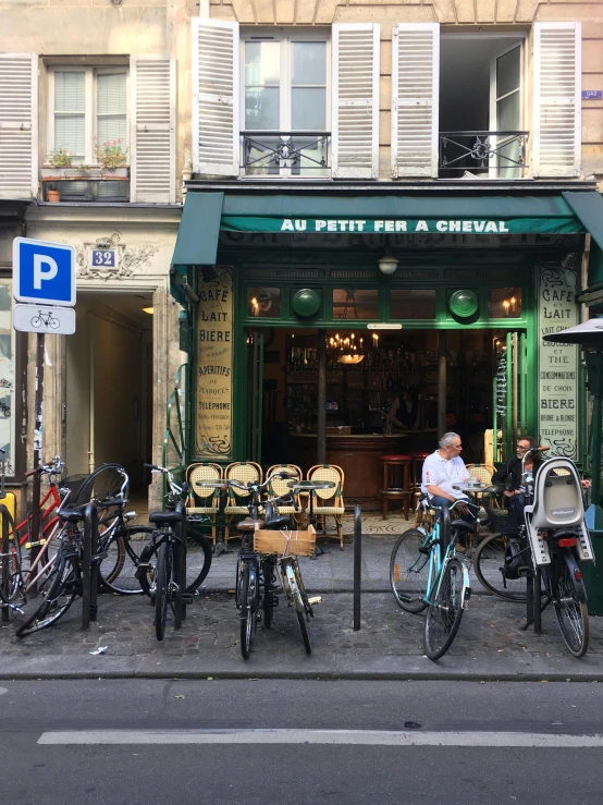 a group of bicycles parked in front of a restaurant, profile image, pantheon, exterior photo, green alleys