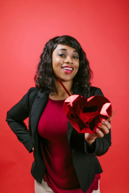 a woman in a black jacket holding a red rose, by Dorothy Bradford, pexels contest winner, on a red background, giving gifts to people, square, african american young woman