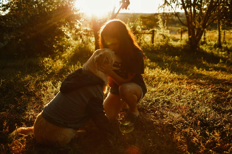 a woman kneeling in the grass with a dog, by Emma Andijewska, pexels contest winner, warmly lit, aussie, embrace, instagram post