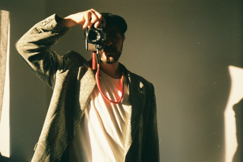 a man taking a picture of himself with a camera, by Pablo Rey, unsplash, photorealism, faded color film, outfit photograph, lo-fi, shot on red camera