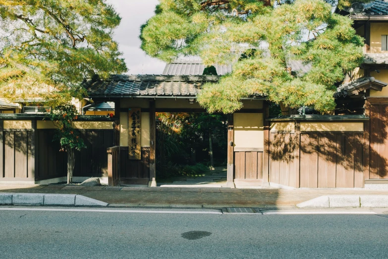 a red fire hydrant sitting on the side of a road, inspired by Tōshi Yoshida, unsplash, shin hanga, peaceful wooden mansion, wearing a haori, with matsu pine trees, large gate