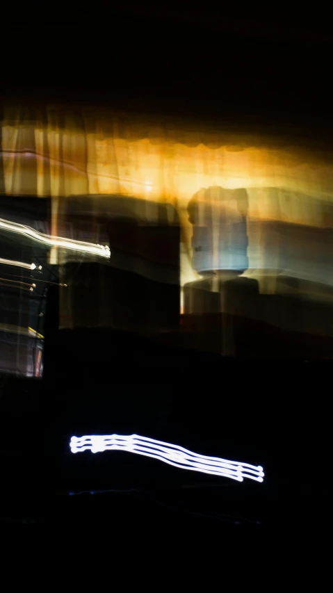 a blurry photo of a city at night, a hologram, by Michael Goldberg, lyrical abstraction, long exposure ; sharp focus, (abstract), ( ( stage lights ) ), photographed for reuters