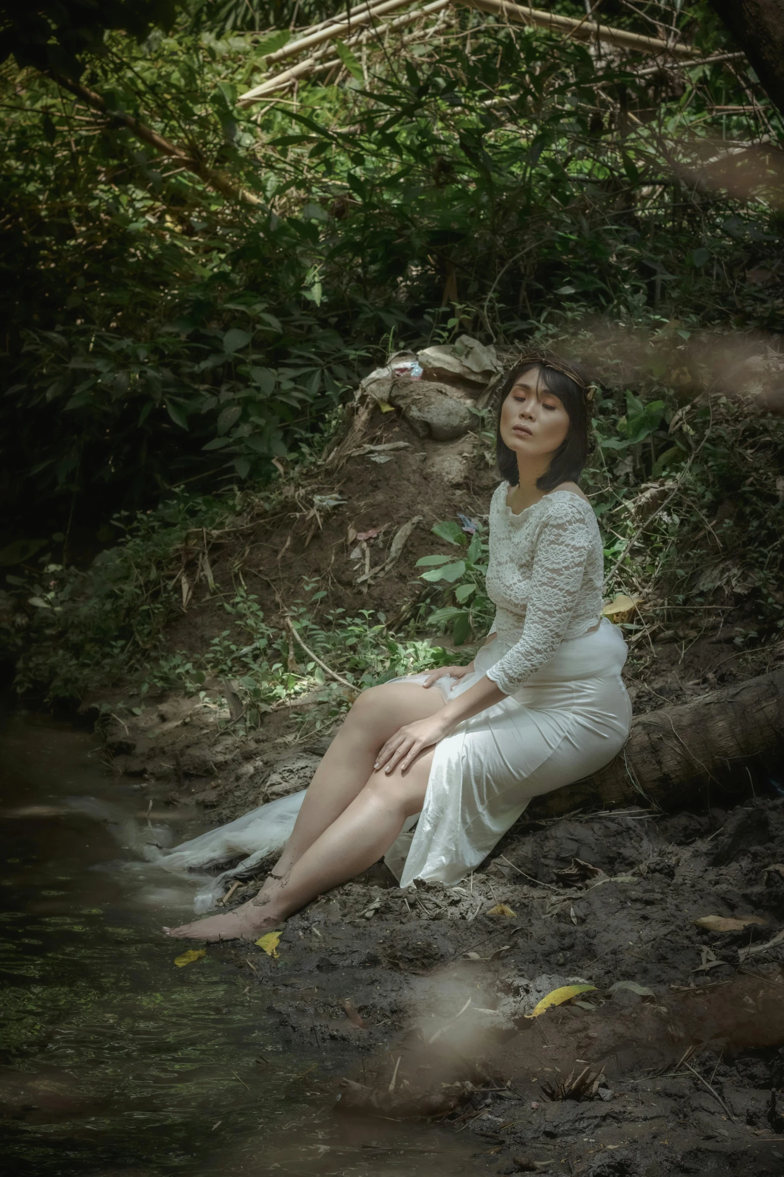 a woman in a white dress sitting on the ground, pexels contest winner, sumatraism, creek, classic portrait, low quality photo, medium format