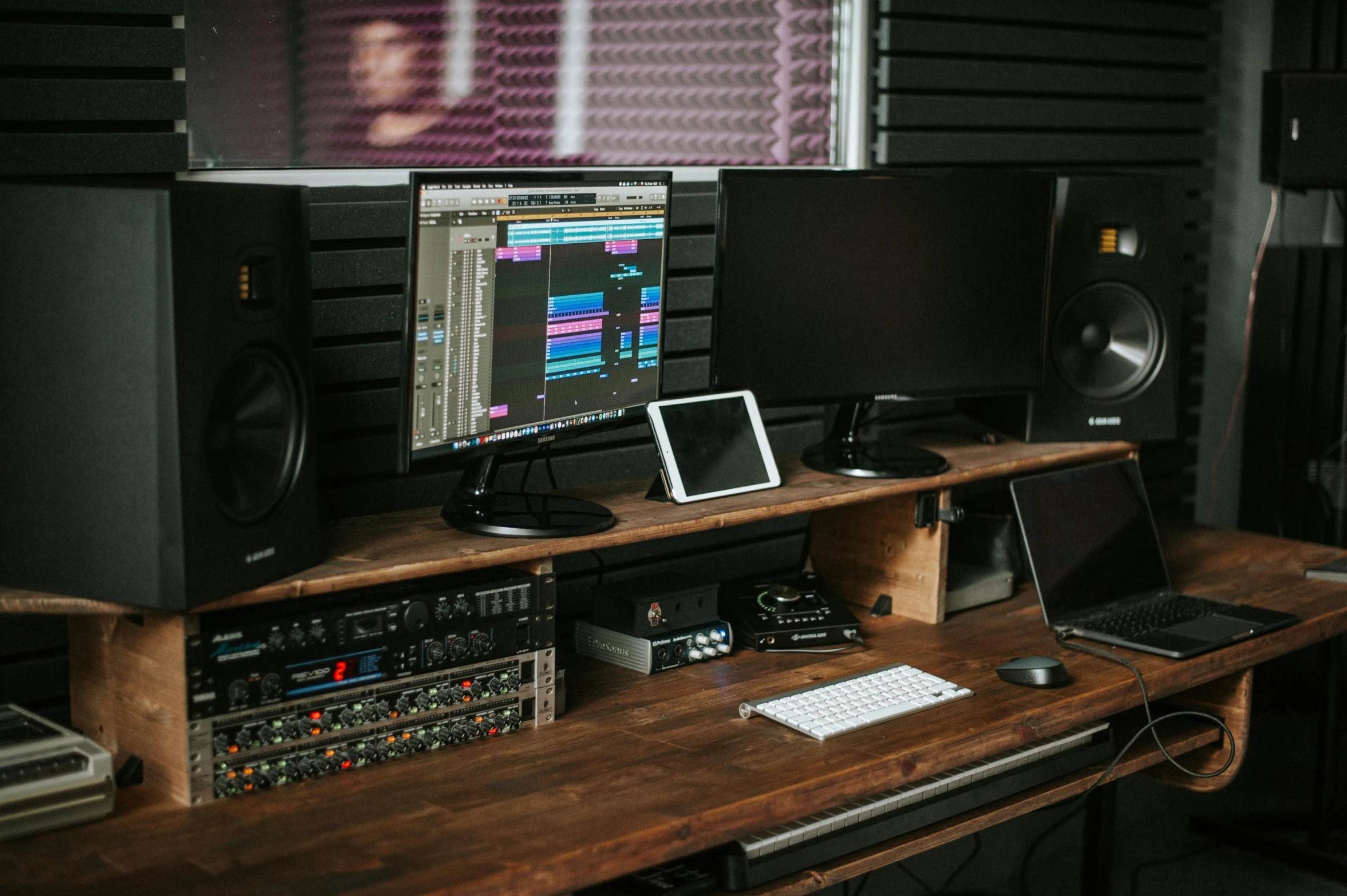 a laptop computer sitting on top of a wooden desk, audio equipments, stacked computer screens, innate studio, brown