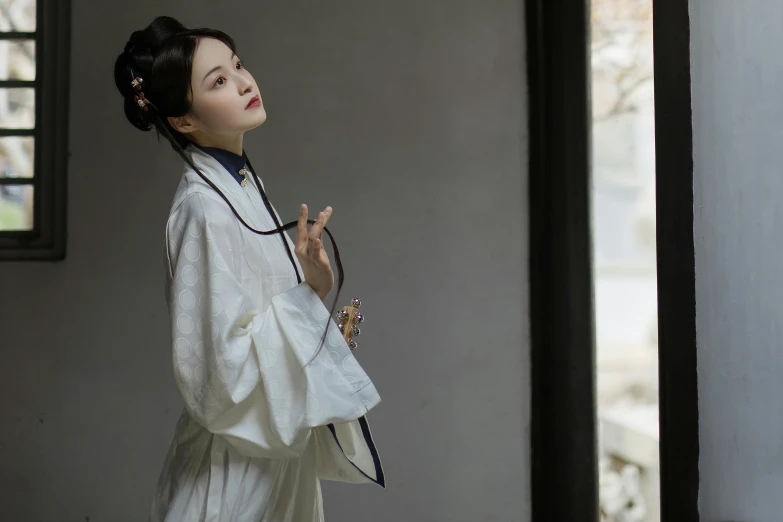 a woman in a white robe standing next to a window, an album cover, inspired by Gu An, aestheticism, changquan, illustrious clothes, thoughtful ), lunar themed attire