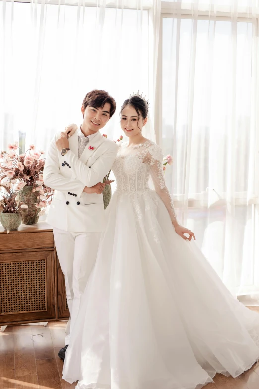 a man in a white suit standing next to a woman in a white dress, inspired by Zhang Han, wearing a wedding dress, background image, thumbnail, wearing long gown