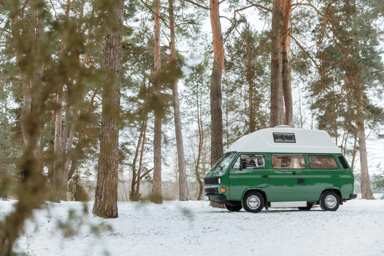 a green van is parked in the snow, a photo, by Emma Andijewska, unsplash contest winner, hurufiyya, forest picnic, 🎀 🗡 🍓 🧚, 80s nostalgia, panoramic shot