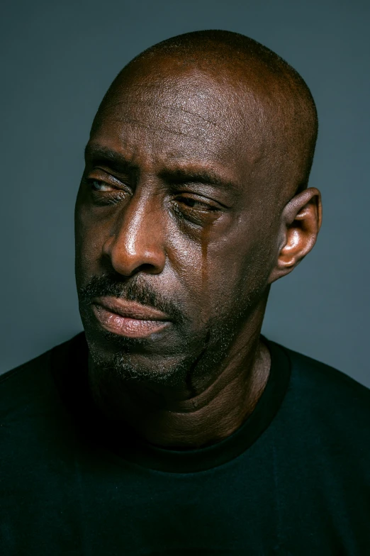 a close up of a man wearing a black shirt, an album cover, inspired by Terrell James, trending on pexels, hyperrealism, tony hawk crying, kevin garnett, nicholas cage, acting headshot