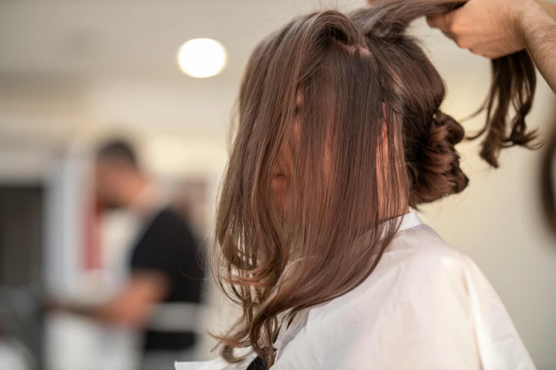 a woman getting her hair done in a salon, pexels contest winner, shoulder-length brown hair, half turned around, filling the frame, full colour