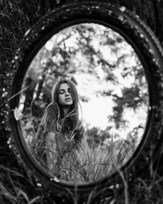 a black and white photo of a woman in a mirror, a black and white photo, unsplash, conceptual art, in the grass, looking at us from a porthole, (beautiful) girl, ffffound