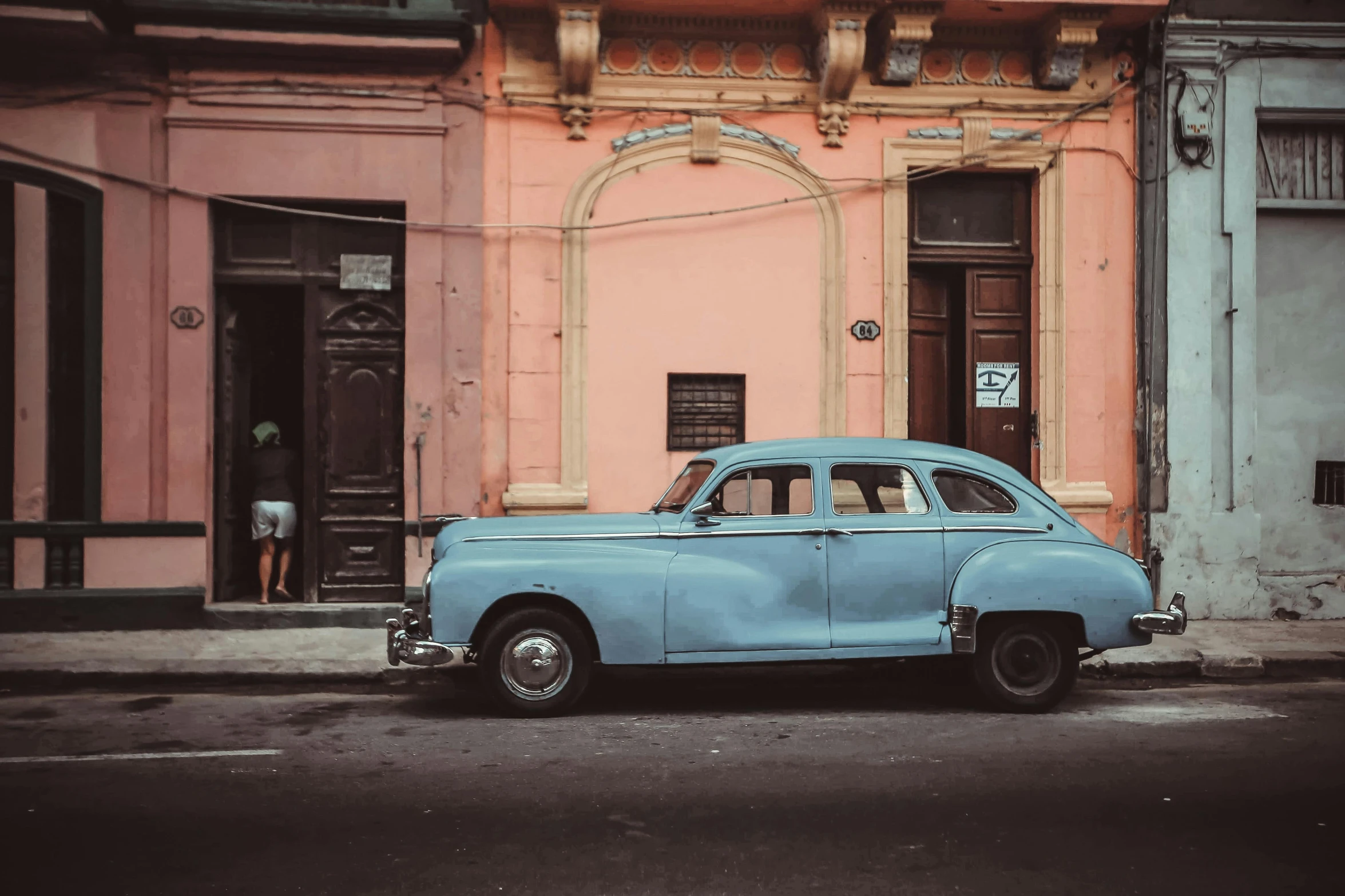 a blue car parked in front of a pink building, a colorized photo, pexels contest winner, square, patina, hispanic, profile image