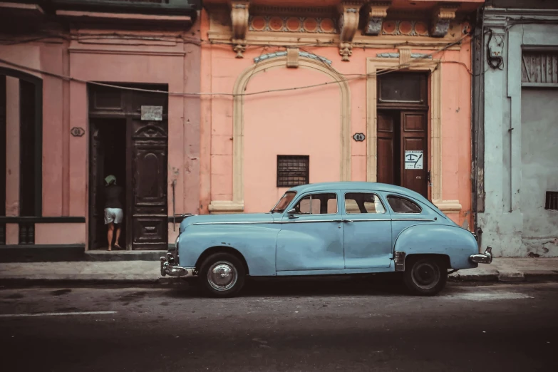 a blue car parked in front of a pink building, a colorized photo, pexels contest winner, square, patina, hispanic, profile image