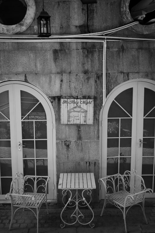 a black and white photo of a table and chairs, a black and white photo, by Maurycy Gottlieb, signboards, esthetic photo, porches, 2 5 6 x 2 5 6
