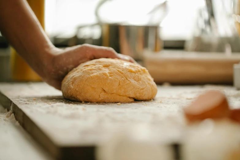 a person kn kn kn kn kn kn kn kn kn kn kn kn kn kn kn kn kn kn kn kn kn kn kn kn kn kn, by Tom Bonson, trending on pexels, holding a baguette, ingredients on the table, back of hand on the table, cooking