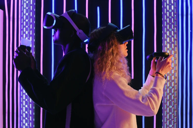 a man and a woman wearing virtual reality headsets, by Julia Pishtar, pexels, interactive art, neon-noir background, middle shot, item, handheld