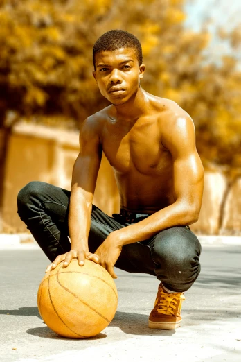 a man squatting down with a basketball in his hand, by Greg Spalenka, trending on dribble, kano), male teenager, smooth golden skin, instagram photo