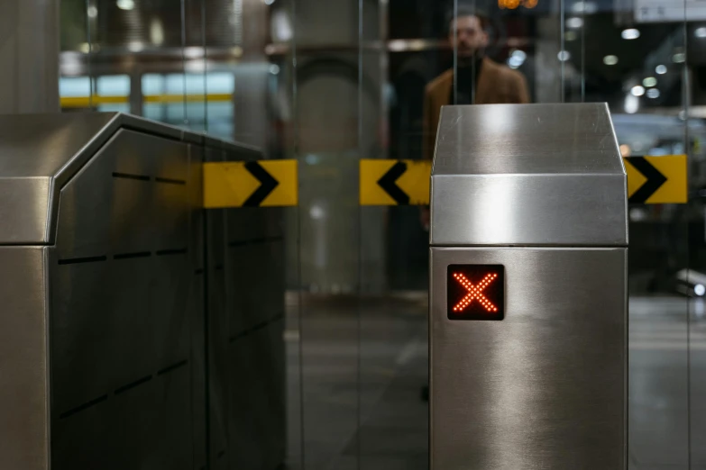 a close up of a metal object with a red light, pexels contest winner, excessivism, mta subway entrance, square, stainless steel, brown