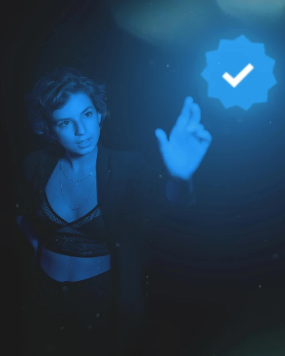 a woman standing in front of a blue light, inspired by Elsa Bleda, trending on reddit, holography, thumb up, sexy :8, epk, heavily upvoted