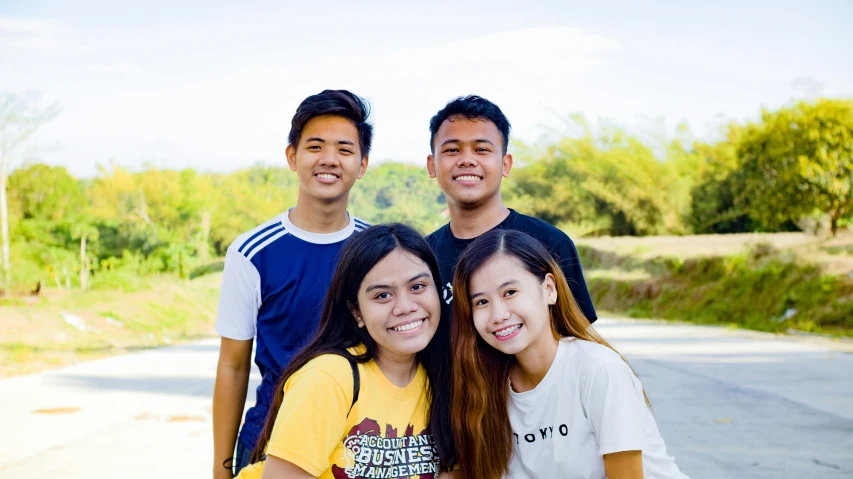 a group of people standing next to each other on a road, by Robbie Trevino, smiling, avatar image, philippines, background image
