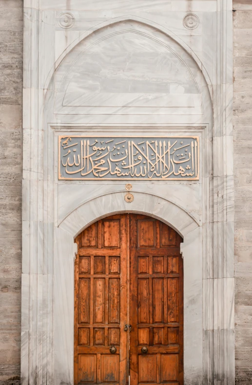 a couple of wooden doors sitting in front of a building, inspired by Osman Hamdi Bey, trending on pexels, arabesque, made of carrara marble, calligraphy, impressive detail : 7, single panel