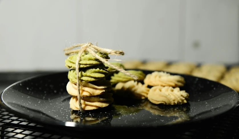 a black plate topped with pasta and asparagus, by Emma Andijewska, pexels contest winner, baking cookies, stacked image, 2 4 mm iso 8 0 0 color, cookies