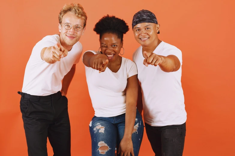 a group of three people standing next to each other, pexels, antipodeans, white and orange, doing a sassy pose, half african, with a white complexion