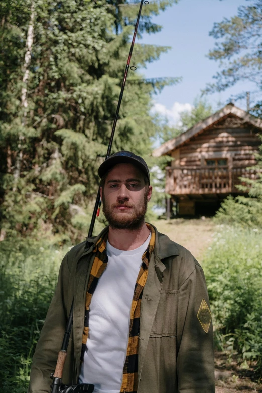 a man standing in the woods with a fishing rod, a portrait, by Anato Finnstark, unsplash, stood outside a wooden cabin, post malone, russia, midsommar - t