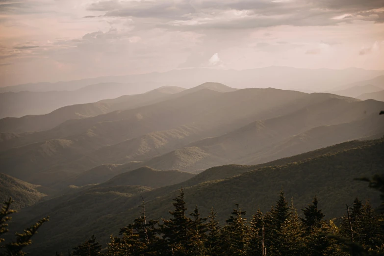 a view of the mountains from the top of a hill, inspired by LeConte Stewart, unsplash contest winner, moody muted colors, summer evening, 2000s photo, fan favorite