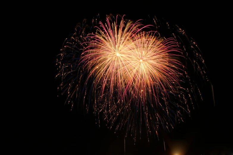 a fireworks is lit up in the night sky, pexels, hurufiyya, 2 5 6 x 2 5 6 pixels, taken in the late 2010s, gold, a colorful